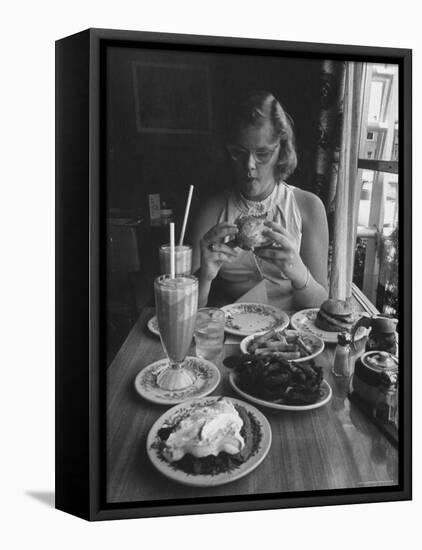 Teenaged Girl Sitting in Drugstore Eating a Hamburger-Hank Walker-Framed Premier Image Canvas