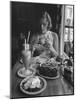 Teenaged Girl Sitting in Drugstore Eating a Hamburger-Hank Walker-Mounted Photographic Print