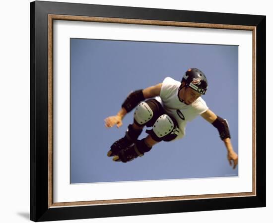 Teenager Inline Skating in Mid-Air-null-Framed Photographic Print