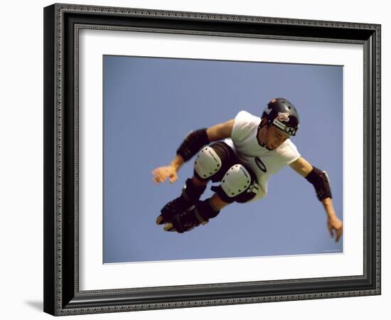 Teenager Inline Skating in Mid-Air-null-Framed Photographic Print