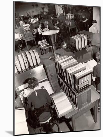 Telephone Operators Consulting Local and Long Distance Books and Directories, New York Telephone Co-Margaret Bourke-White-Mounted Photographic Print