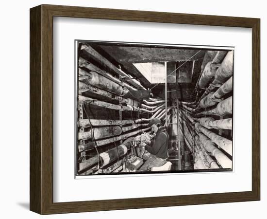 Telephone Repair Man Splicing a Wire in a Manhole for Telephone Cables of the New York Telephone Co-Margaret Bourke-White-Framed Photographic Print