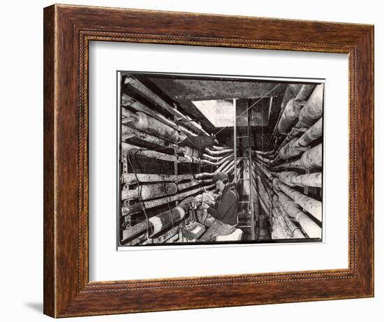 Telephone Repair Man Splicing a Wire in a Manhole for Telephone Cables of the New York Telephone Co-Margaret Bourke-White-Framed Photographic Print