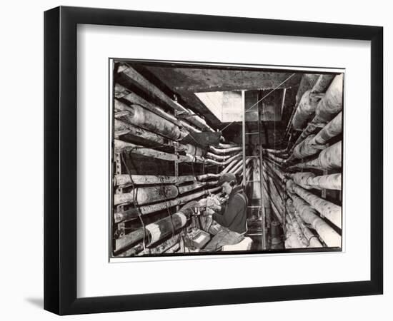 Telephone Repair Man Splicing a Wire in a Manhole for Telephone Cables of the New York Telephone Co-Margaret Bourke-White-Framed Photographic Print