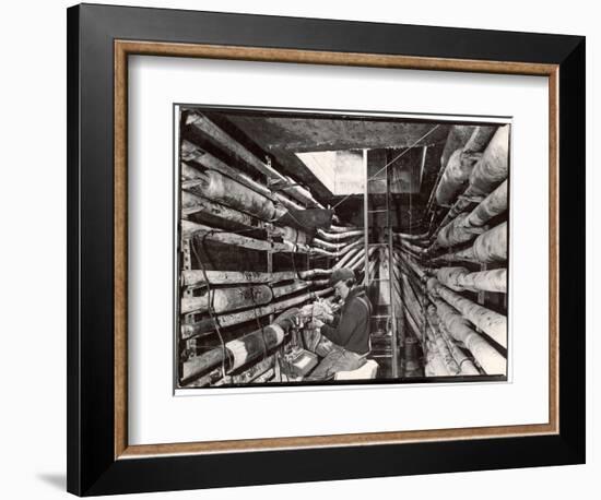 Telephone Repair Man Splicing a Wire in a Manhole for Telephone Cables of the New York Telephone Co-Margaret Bourke-White-Framed Photographic Print