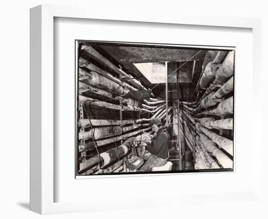 Telephone Repair Man Splicing a Wire in a Manhole for Telephone Cables of the New York Telephone Co-Margaret Bourke-White-Framed Photographic Print