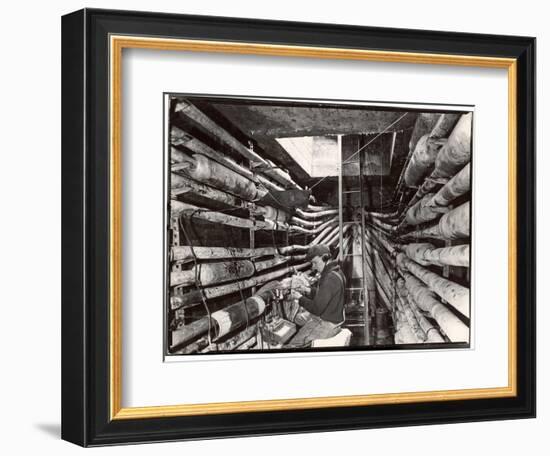 Telephone Repair Man Splicing a Wire in a Manhole for Telephone Cables of the New York Telephone Co-Margaret Bourke-White-Framed Photographic Print