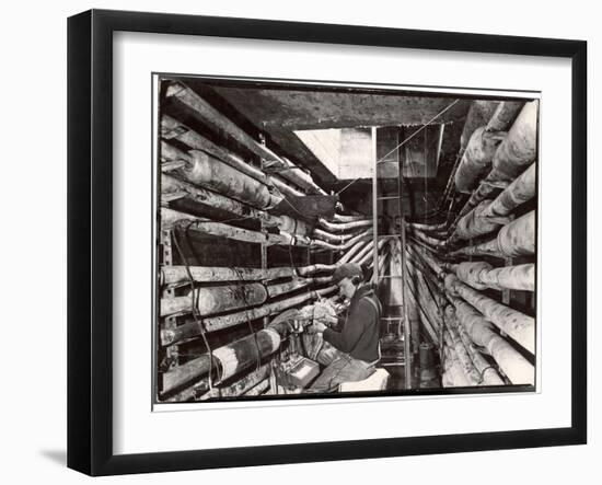 Telephone Repair Man Splicing a Wire in a Manhole for Telephone Cables of the New York Telephone Co-Margaret Bourke-White-Framed Photographic Print