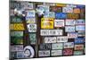 Telluride, Colorado: License Plates Hang On A Fence On A Home In An Alleyway In Downtown Telluride-Ian Shive-Mounted Photographic Print