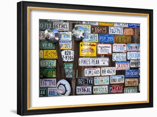 Telluride, Colorado: License Plates Hang On A Fence On A Home In An Alleyway In Downtown Telluride-Ian Shive-Framed Photographic Print