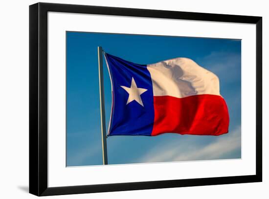 TEXAS STATE FLAG - Texas "Lone Star" flag stands out against a cloudless blue sky as it flys in...-null-Framed Photographic Print