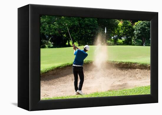 Thai Young Man Golf Player in Action Swing in Sand Pit during Practice before Golf Tournament at Go-Kitzero-Framed Premier Image Canvas