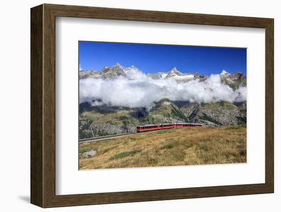 The Bahn Train on its Route with High Peaks and Mountain Range in the Background, Switzerland-Roberto Moiola-Framed Photographic Print