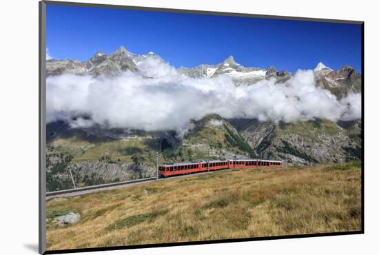 The Bahn Train on its Route with High Peaks and Mountain Range in the Background, Switzerland-Roberto Moiola-Mounted Photographic Print