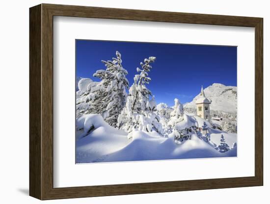The bell tower submerged by snow surrounded by woods Maloja Canton of Engadine Switzerland Europe-ClickAlps-Framed Photographic Print