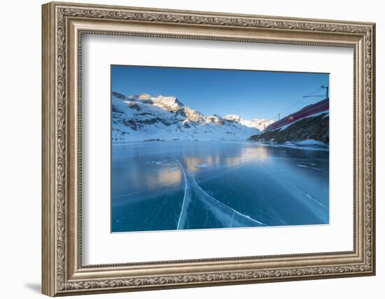 The Bernina Express train runs beside the frozen Lago Bianco, Bernina Pass, canton of Graubunden, E-Roberto Moiola-Framed Photographic Print