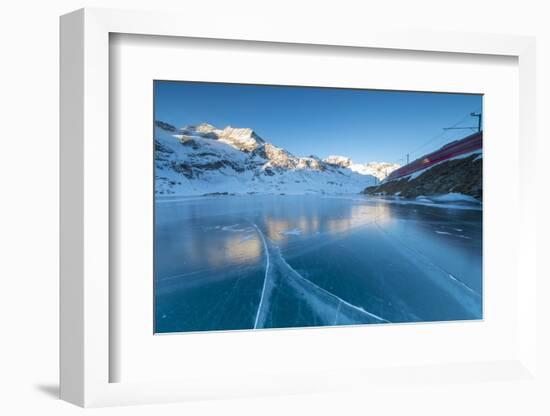 The Bernina Express train runs beside the frozen Lago Bianco, Bernina Pass, canton of Graubunden, E-Roberto Moiola-Framed Photographic Print