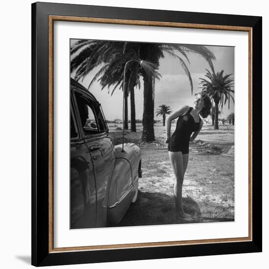 The Cadillac That Has Everything, Jackie Smithwick Taking a Warm Shower Next to the Front Fender-Ed Clark-Framed Photographic Print