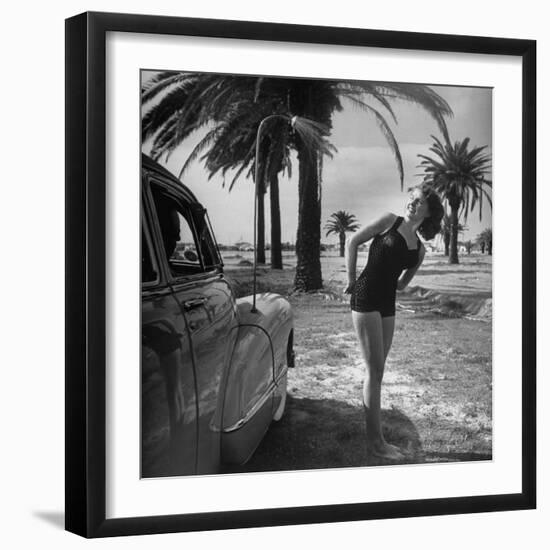 The Cadillac That Has Everything, Jackie Smithwick Taking a Warm Shower Next to the Front Fender-Ed Clark-Framed Photographic Print