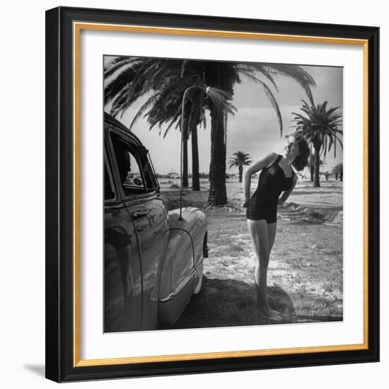 The Cadillac That Has Everything, Jackie Smithwick Taking a Warm Shower Next to the Front Fender-Ed Clark-Framed Photographic Print