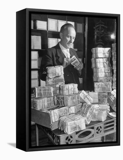 The Chief Cashier Counting Piles of Money-Walter Sanders-Framed Premier Image Canvas