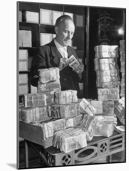 The Chief Cashier Counting Piles of Money-Walter Sanders-Mounted Photographic Print