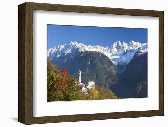 The colorful trees frame the alpine church and the snowy peaks, Soglio, Bregaglia Valley, Canton of-Roberto Moiola-Framed Photographic Print