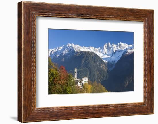 The colorful trees frame the alpine church and the snowy peaks, Soglio, Bregaglia Valley, Canton of-Roberto Moiola-Framed Photographic Print