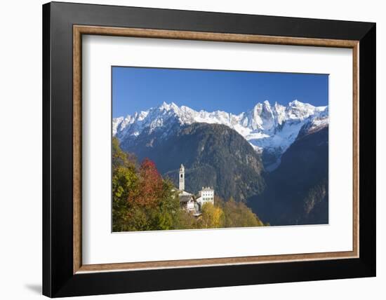 The colorful trees frame the alpine church and the snowy peaks, Soglio, Bregaglia Valley, Canton of-Roberto Moiola-Framed Photographic Print