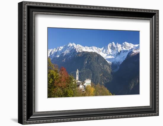 The colorful trees frame the alpine church and the snowy peaks, Soglio, Bregaglia Valley, Canton of-Roberto Moiola-Framed Photographic Print