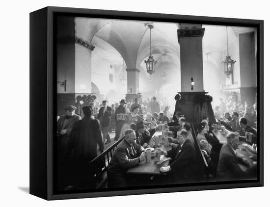 The Hofbrauhaus with Patrons Sitting at Long Tables Holding Large Steins of Beer-Ralph Crane-Framed Premier Image Canvas