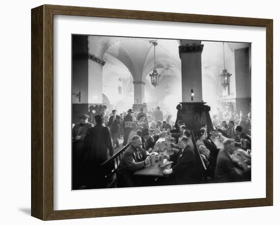 The Hofbrauhaus with Patrons Sitting at Long Tables Holding Large Steins of Beer-Ralph Crane-Framed Photographic Print