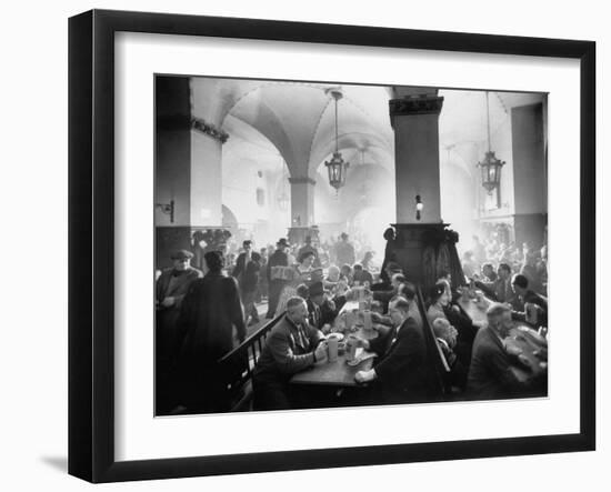 The Hofbrauhaus with Patrons Sitting at Long Tables Holding Large Steins of Beer-Ralph Crane-Framed Photographic Print