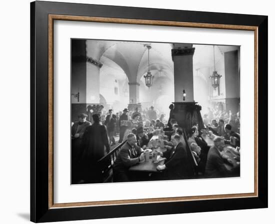 The Hofbrauhaus with Patrons Sitting at Long Tables Holding Large Steins of Beer-Ralph Crane-Framed Photographic Print