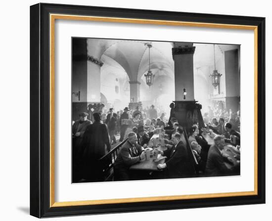 The Hofbrauhaus with Patrons Sitting at Long Tables Holding Large Steins of Beer-Ralph Crane-Framed Photographic Print