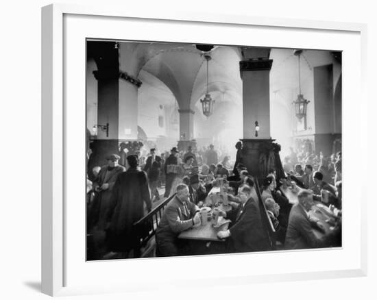 The Hofbrauhaus with Patrons Sitting at Long Tables Holding Large Steins of Beer-Ralph Crane-Framed Premium Photographic Print