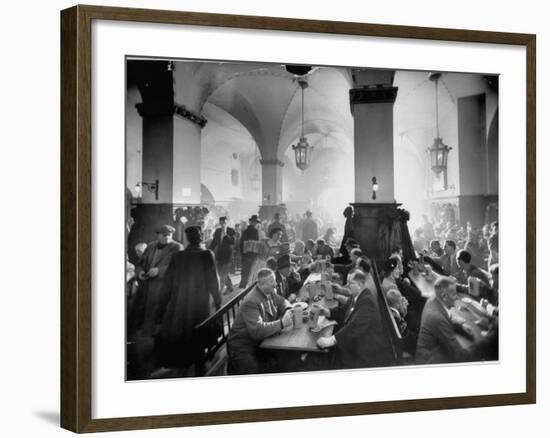 The Hofbrauhaus with Patrons Sitting at Long Tables Holding Large Steins of Beer-Ralph Crane-Framed Premium Photographic Print