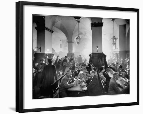 The Hofbrauhaus with Patrons Sitting at Long Tables Holding Large Steins of Beer-Ralph Crane-Framed Premium Photographic Print