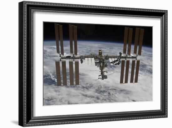 The International Space Station Backdropped Against Clouds over Earth-null-Framed Photographic Print