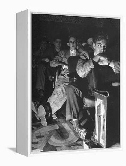 The Local Movie Theater, Boys Have a Very Difficult Time Finding a Place to Put Their Long Legs-Nina Leen-Framed Premier Image Canvas