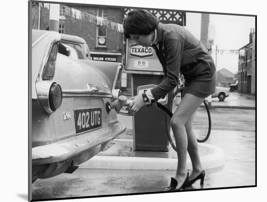 The Modern Female Petrol Pump Operator Refuelling a Car in Her Mini Skirt-null-Mounted Photographic Print