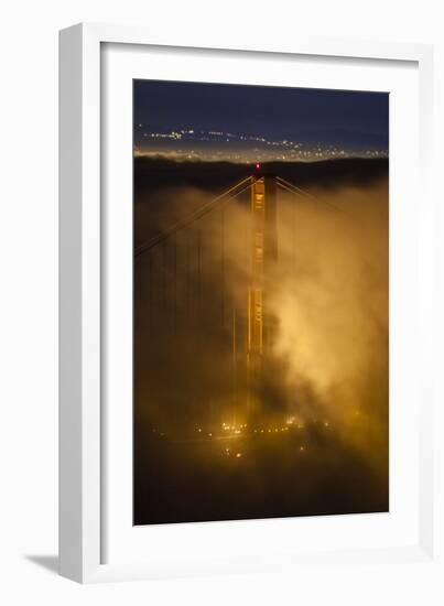 The North Tower Of The Golden Gate Bridge At Night With Fog Swirling In The Lights-Joe Azure-Framed Photographic Print