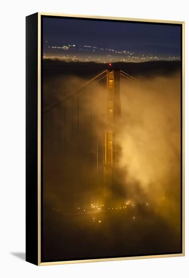 The North Tower Of The Golden Gate Bridge At Night With Fog Swirling In The Lights-Joe Azure-Framed Premier Image Canvas
