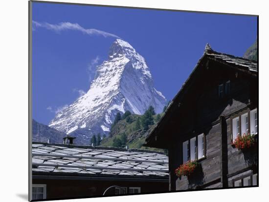 The Peak of the Matterhorn Mountain Towering Above Chalet Rooftops, Swiss Alps, Switzerland-Ruth Tomlinson-Mounted Photographic Print