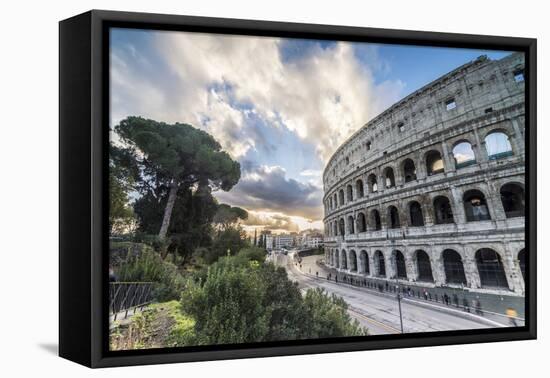 The pink sky at sunrise frames the ancient Colosseum (Flavian Amphitheatre), UNESCO World Heritage -Roberto Moiola-Framed Premier Image Canvas