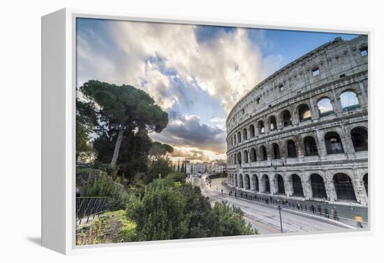 The pink sky at sunrise frames the ancient Colosseum (Flavian Amphitheatre), UNESCO World Heritage -Roberto Moiola-Framed Premier Image Canvas