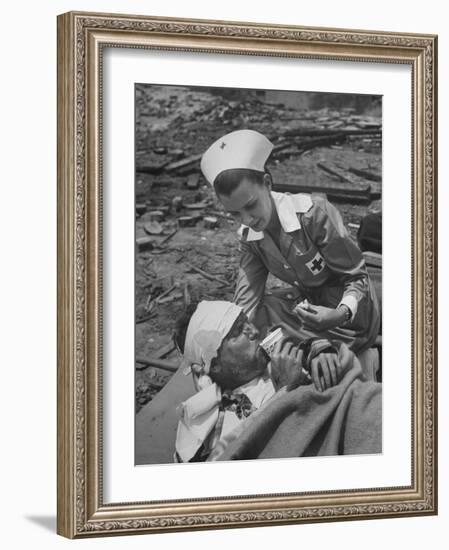 The Red Cross Nurse Trying to Help the Injured Man Eat and Drink-Allan Grant-Framed Photographic Print