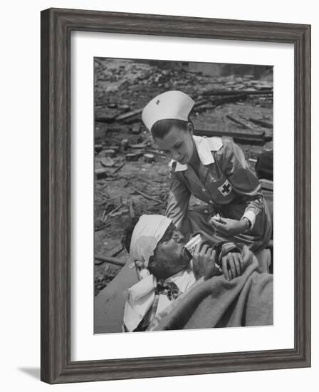 The Red Cross Nurse Trying to Help the Injured Man Eat and Drink-Allan Grant-Framed Photographic Print