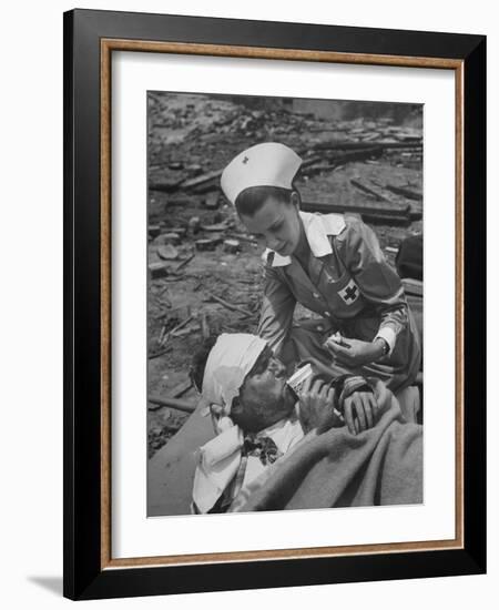 The Red Cross Nurse Trying to Help the Injured Man Eat and Drink-Allan Grant-Framed Photographic Print