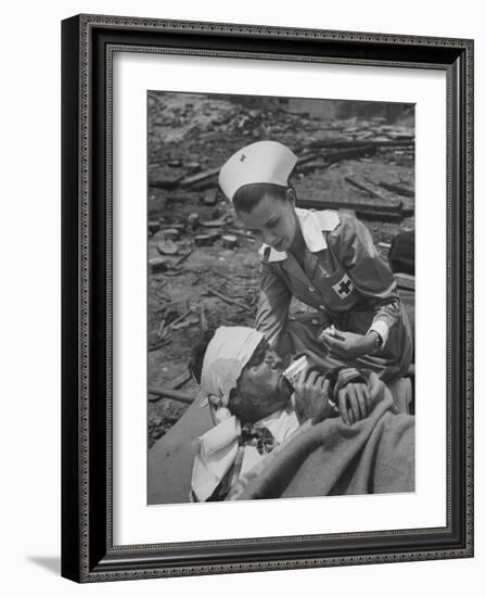 The Red Cross Nurse Trying to Help the Injured Man Eat and Drink-Allan Grant-Framed Photographic Print